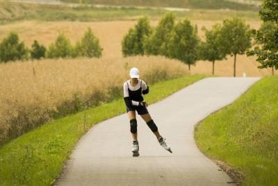 Femme patin à roues alignées sur le chemin